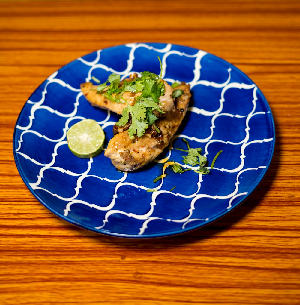 a blue plate topped with chicken covered in cilantro