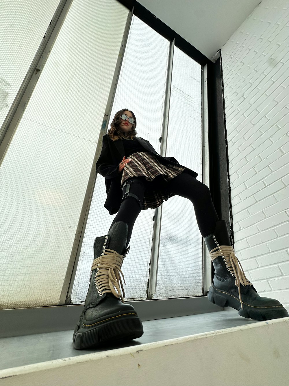 a woman sitting on top of a window sill