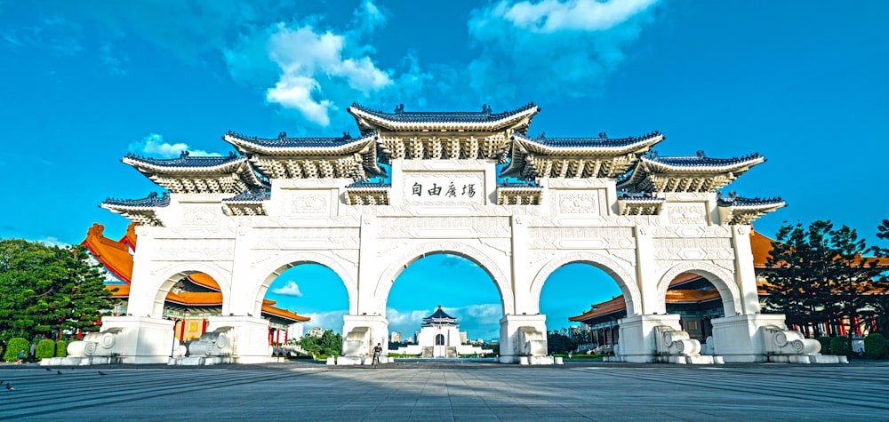 a large white gate with a sky in the background