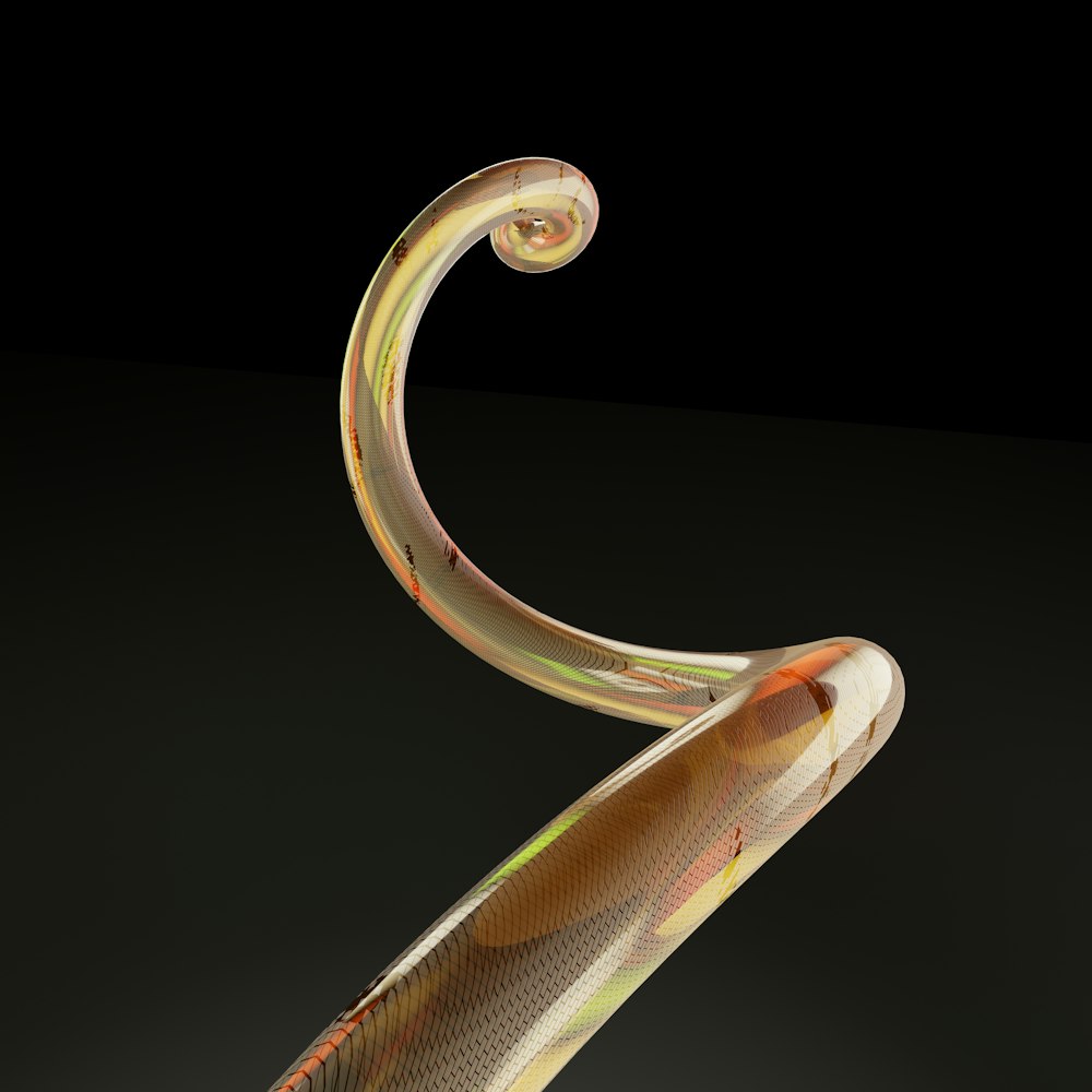 a glass sculpture of a snake on a black background