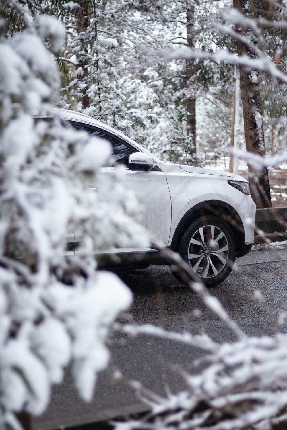 a white car is parked in the snow