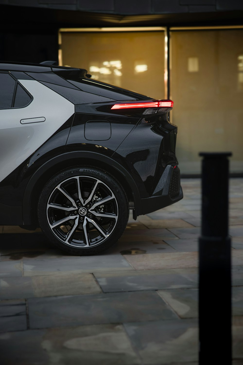 a black and white car parked in front of a building