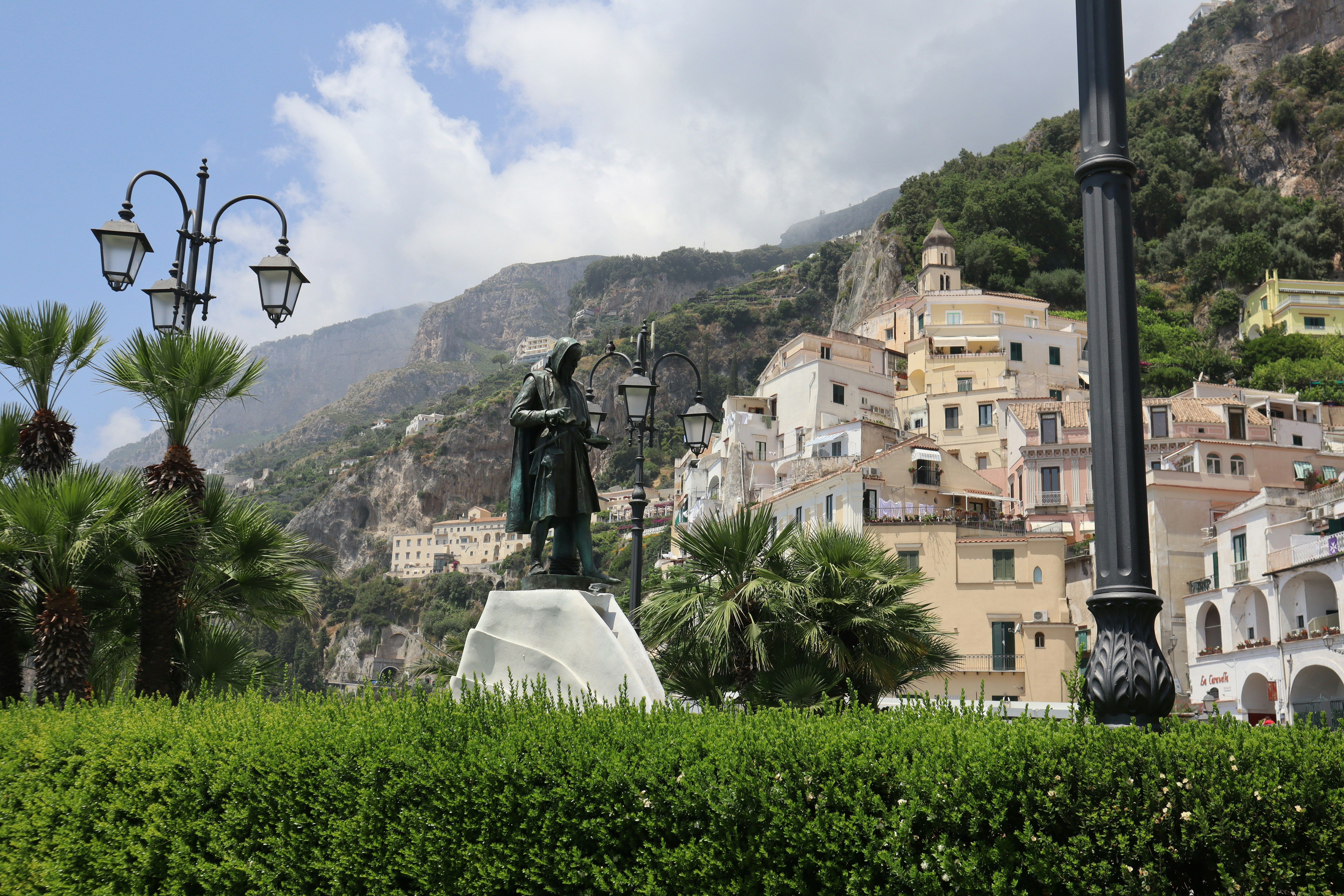a statue of a man standing on top of a white pedestal, 