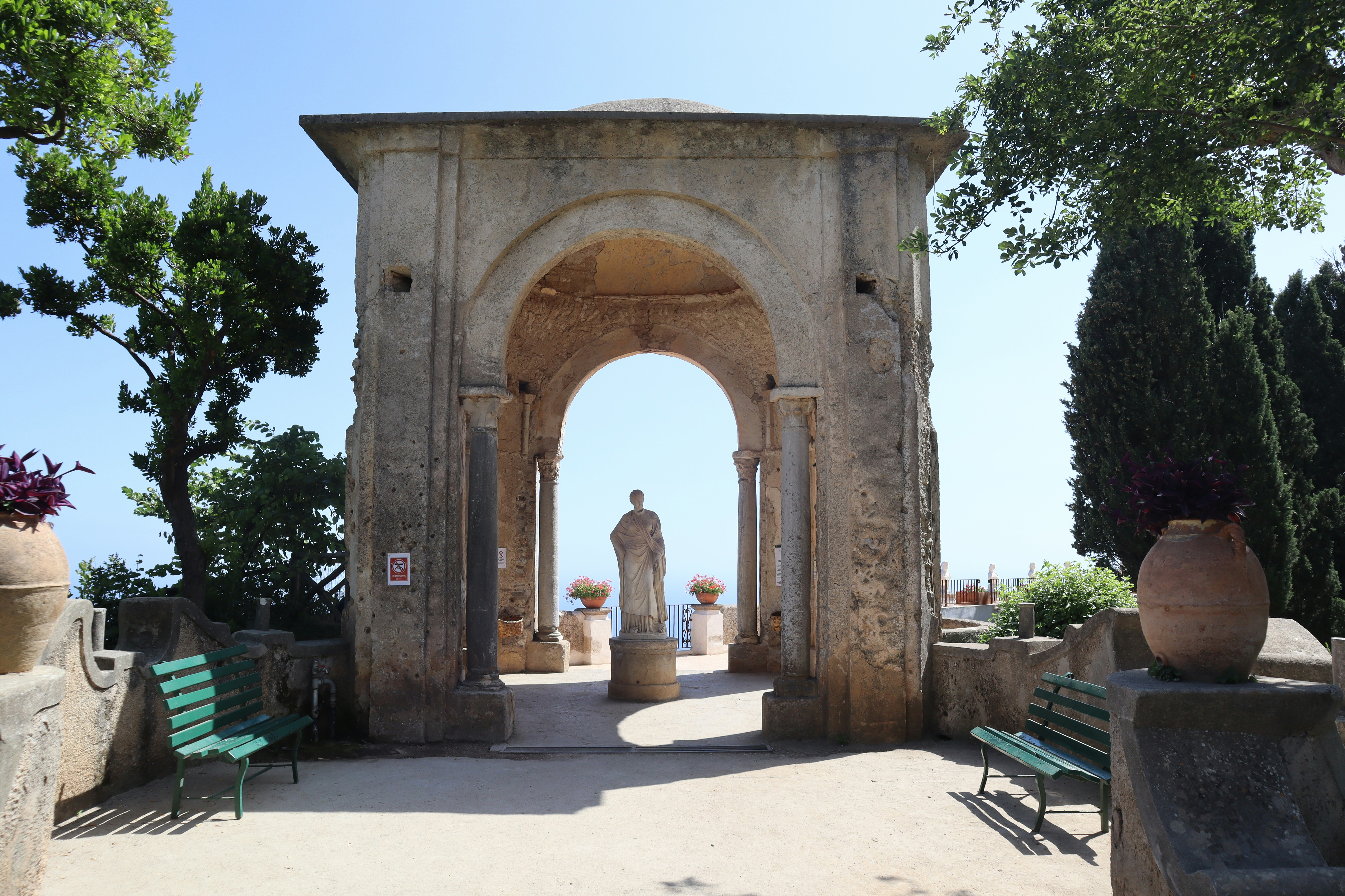 a stone arch with a statue in the middle of it, 