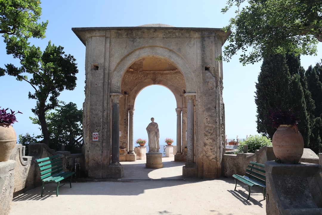 a stone arch with a statue in the middle of it,