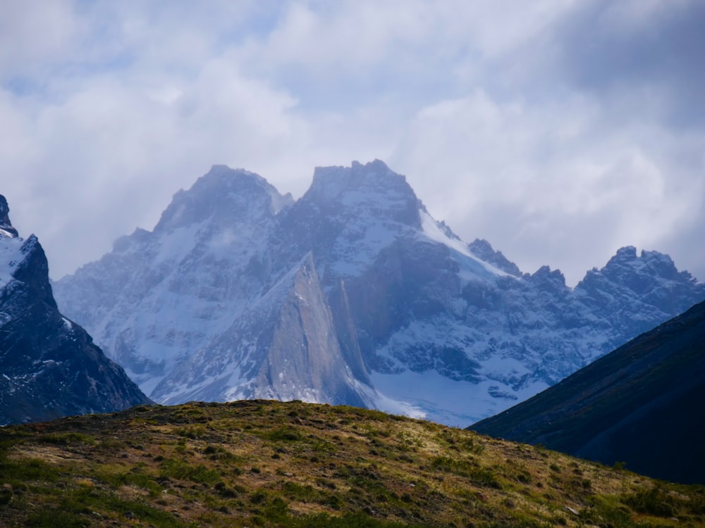 a mountain range with snow covered mountains in the background