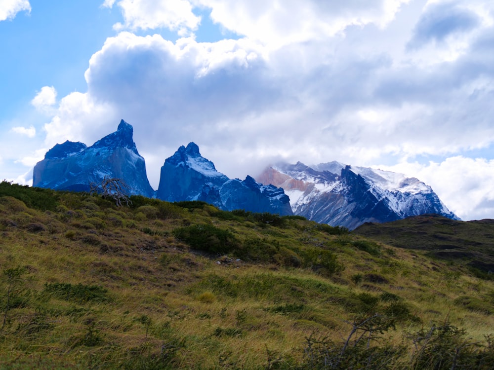 a mountain range with a few snow capped mountains in the distance