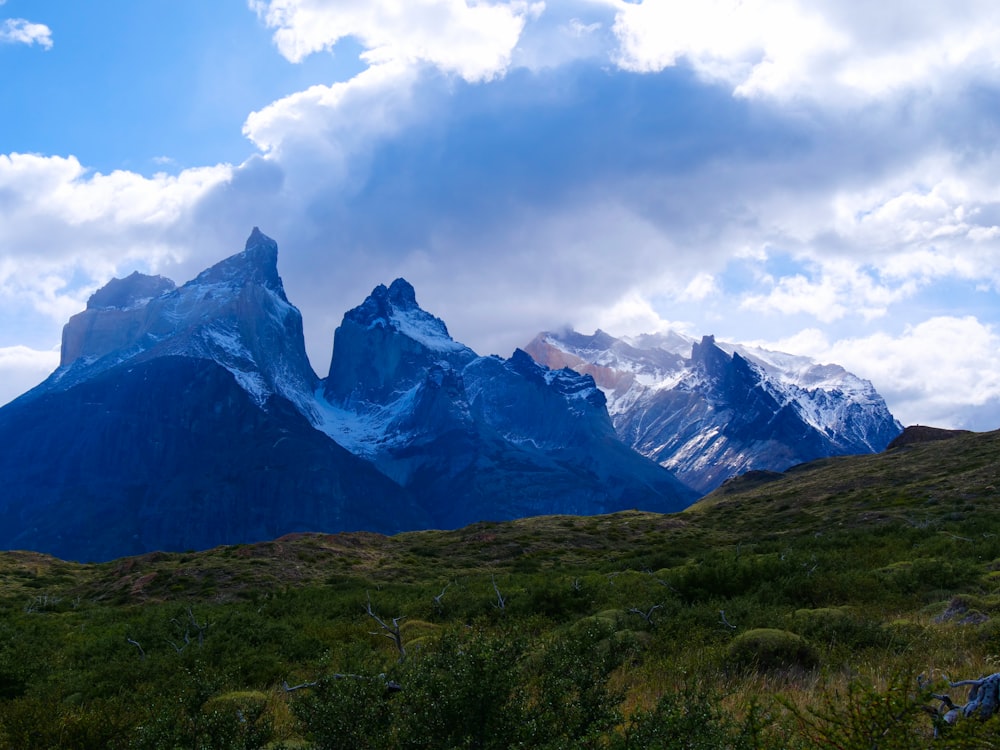 a mountain range with snow capped mountains in the background