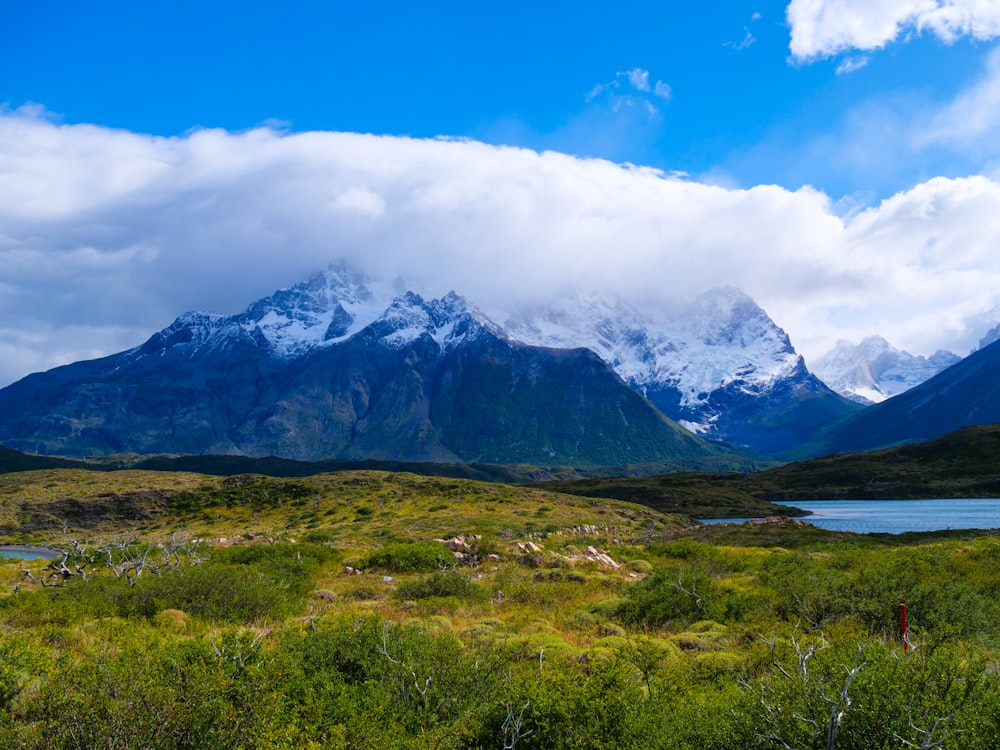 a mountain range with a lake in the foreground