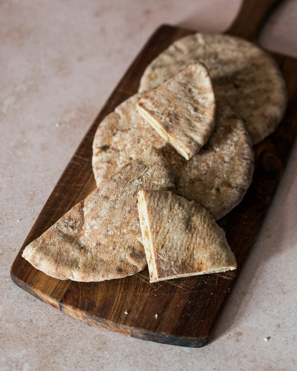 a wooden cutting board topped with pieces of food