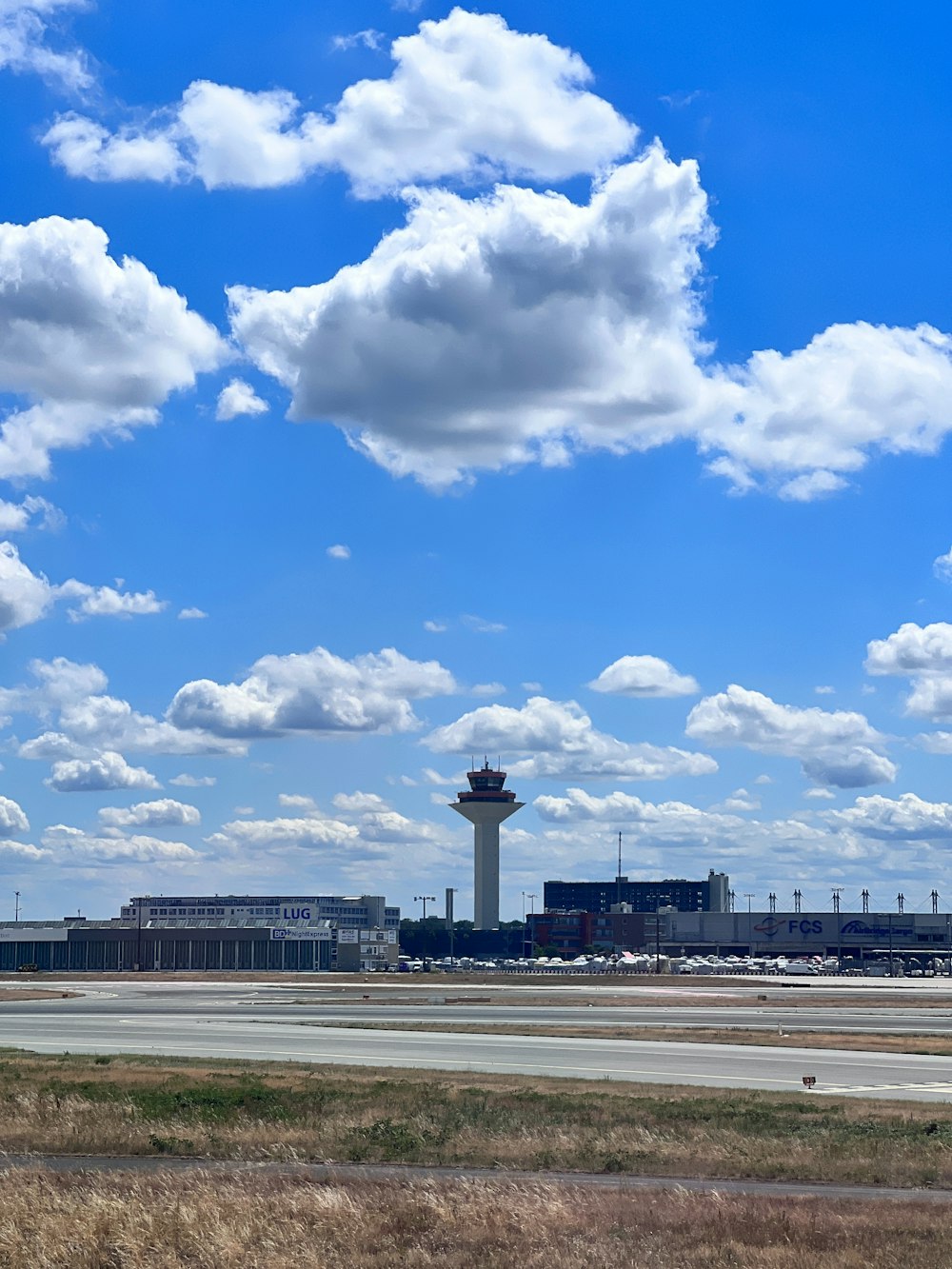 an airport with a tower in the background