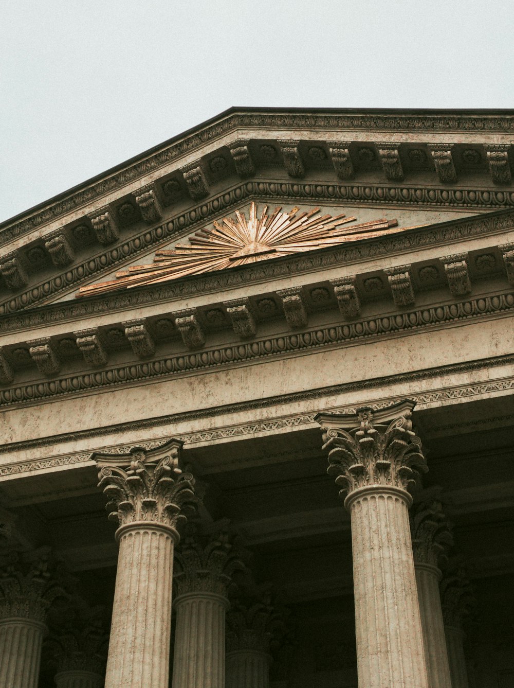 a clock on the side of a building with columns