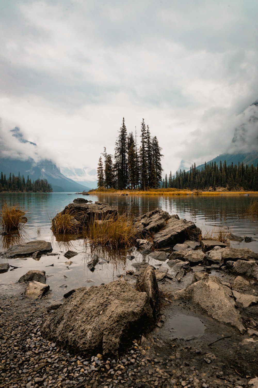 a body of water surrounded by rocks and trees