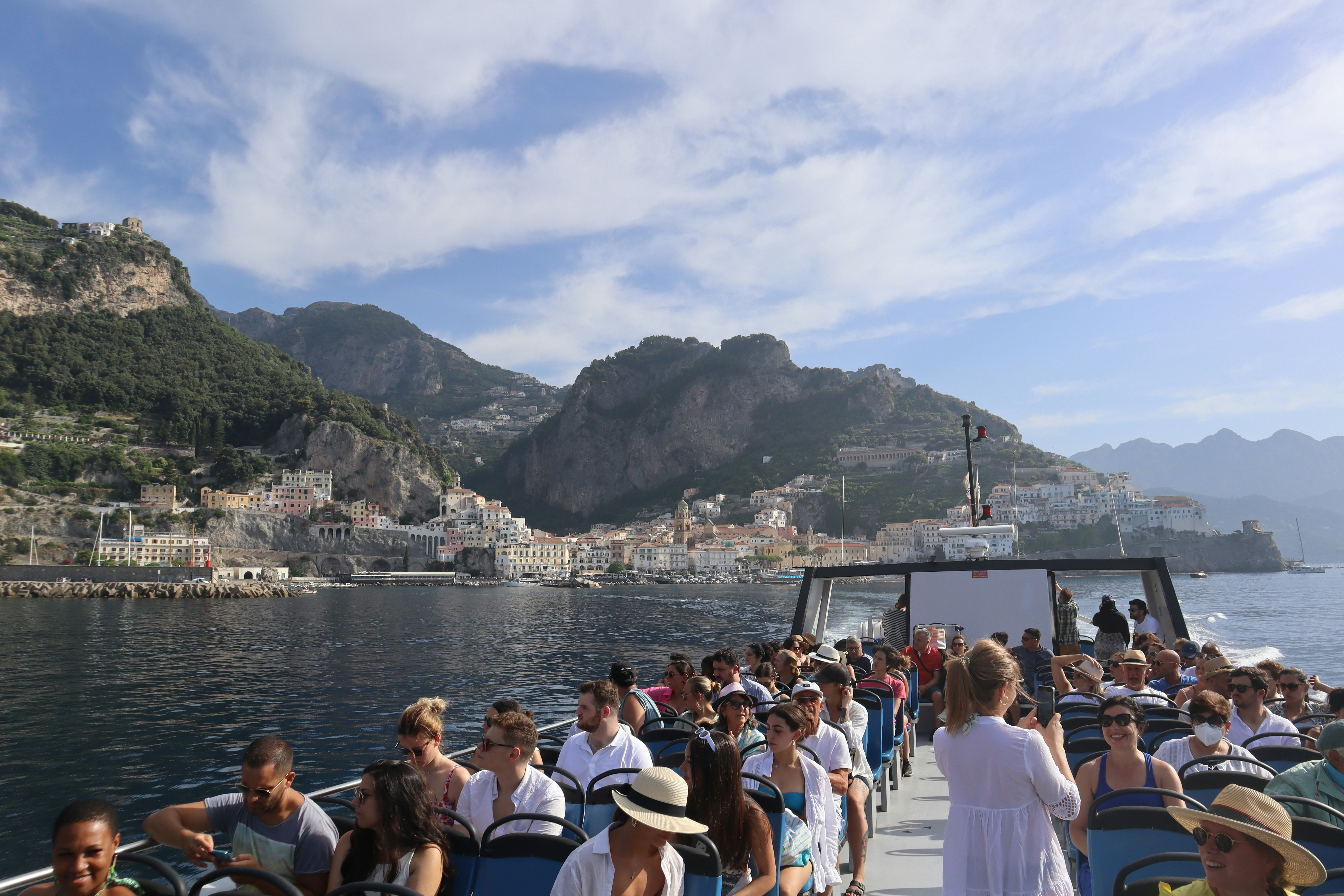 a group of people on a boat on a body of water, 