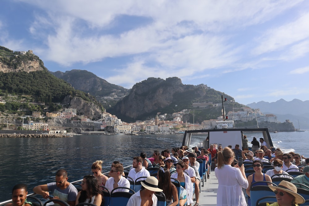 a group of people on a boat on a body of water