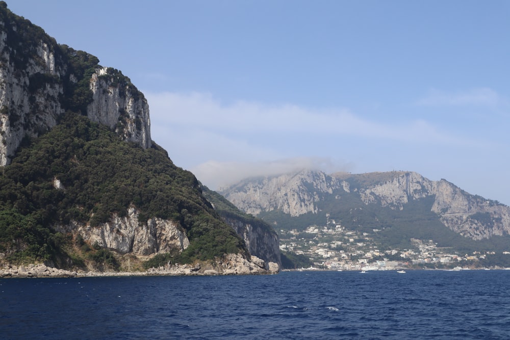 a large body of water with a mountain in the background