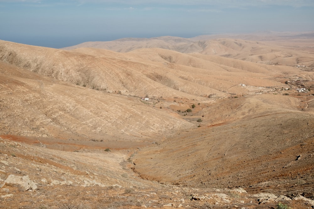 a view of a mountain range with a small village in the distance