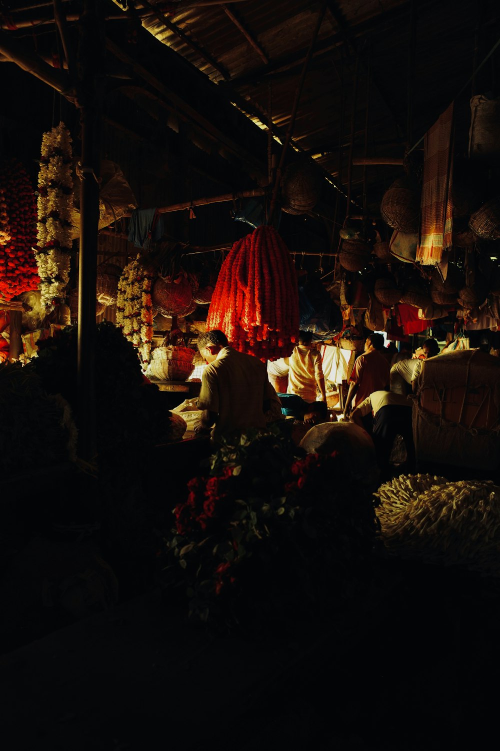 a group of people sitting around a market