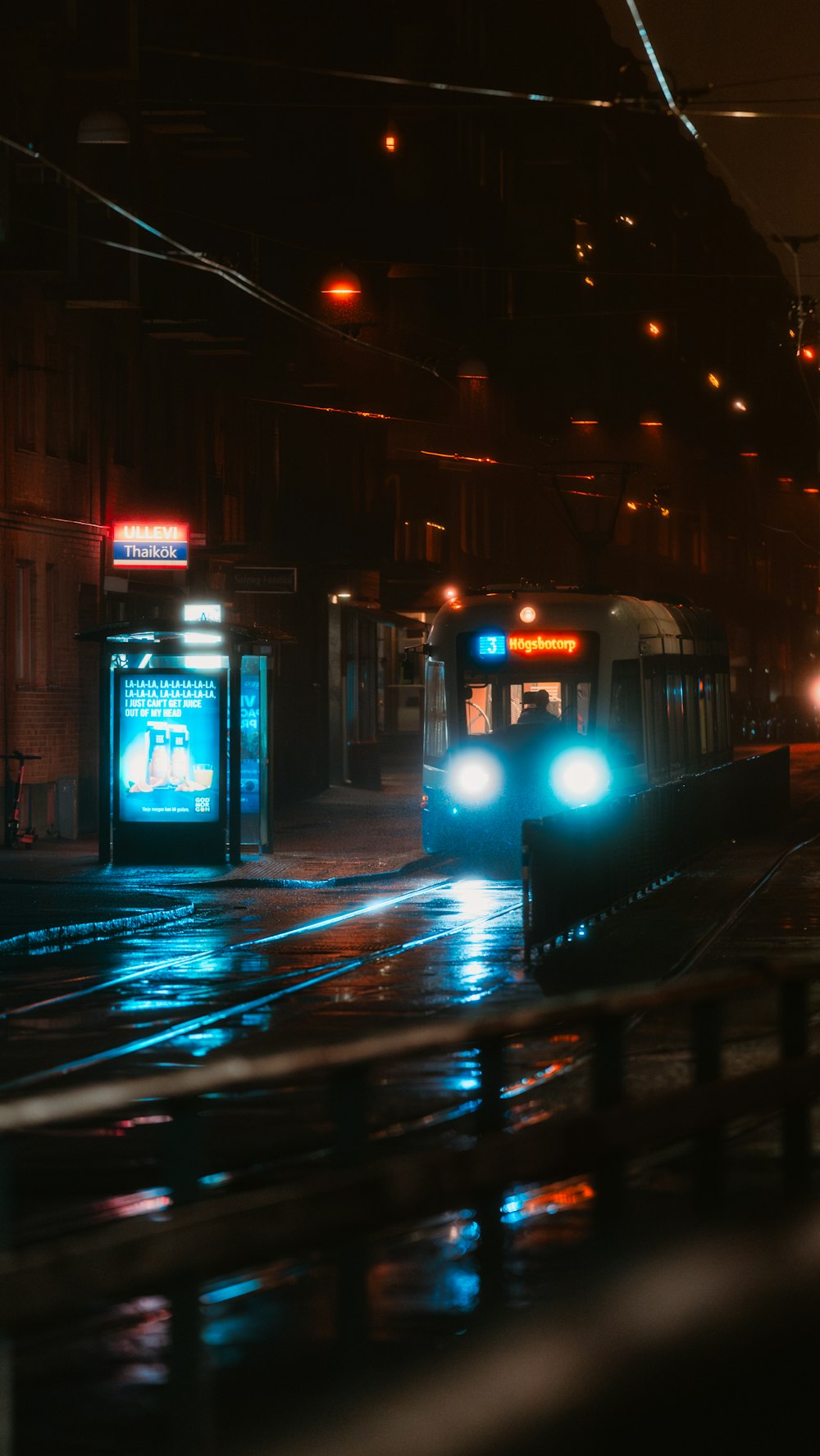 a city bus driving down a street at night