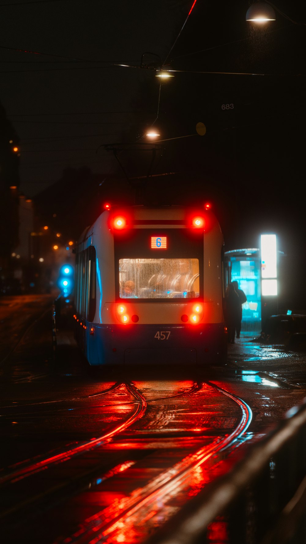 a city bus driving down a street at night