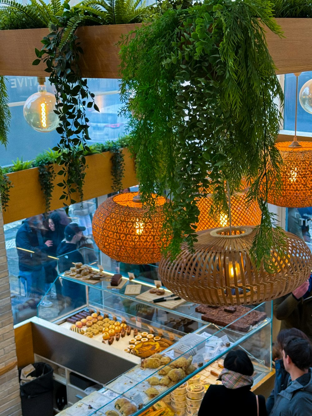 a group of people standing in front of a display of food