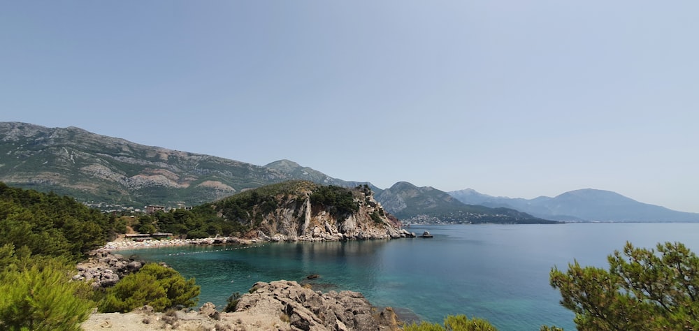 a body of water surrounded by mountains and trees