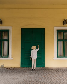 a person standing in front of a green door