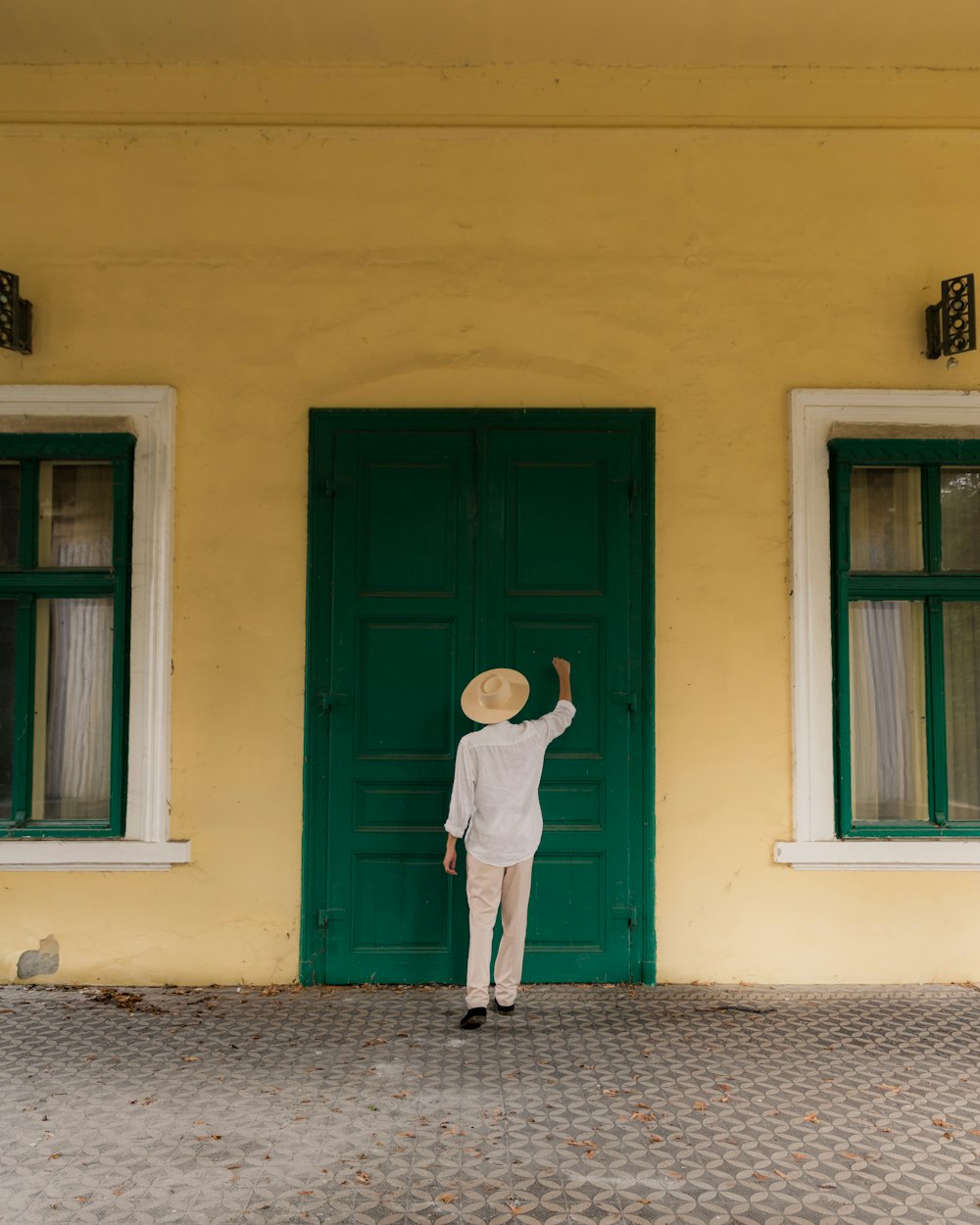 a person standing in front of a green door