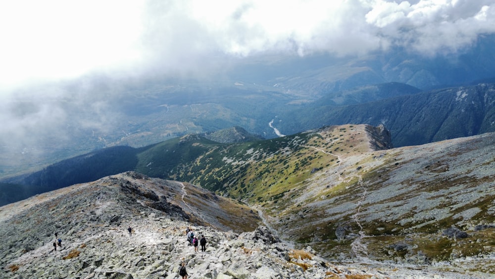 a group of people hiking up the side of a mountain