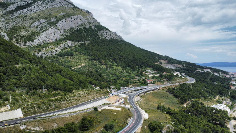 an aerial view of a winding road in the mountains