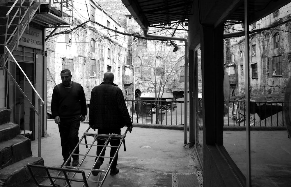 a couple of men walking down a street