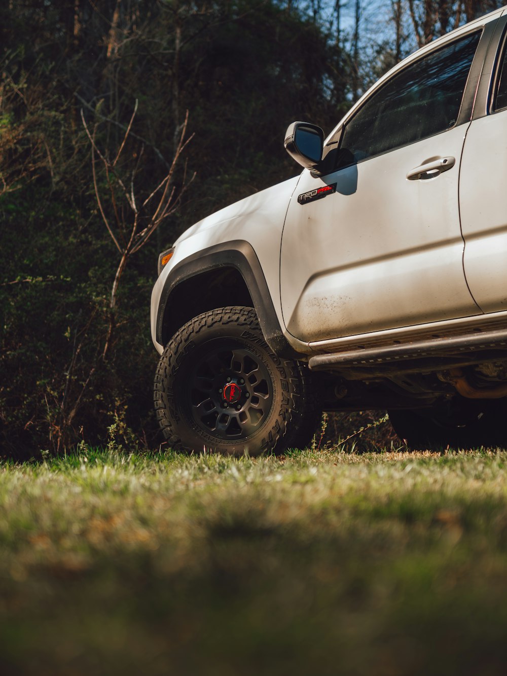 a white truck parked in a grassy field