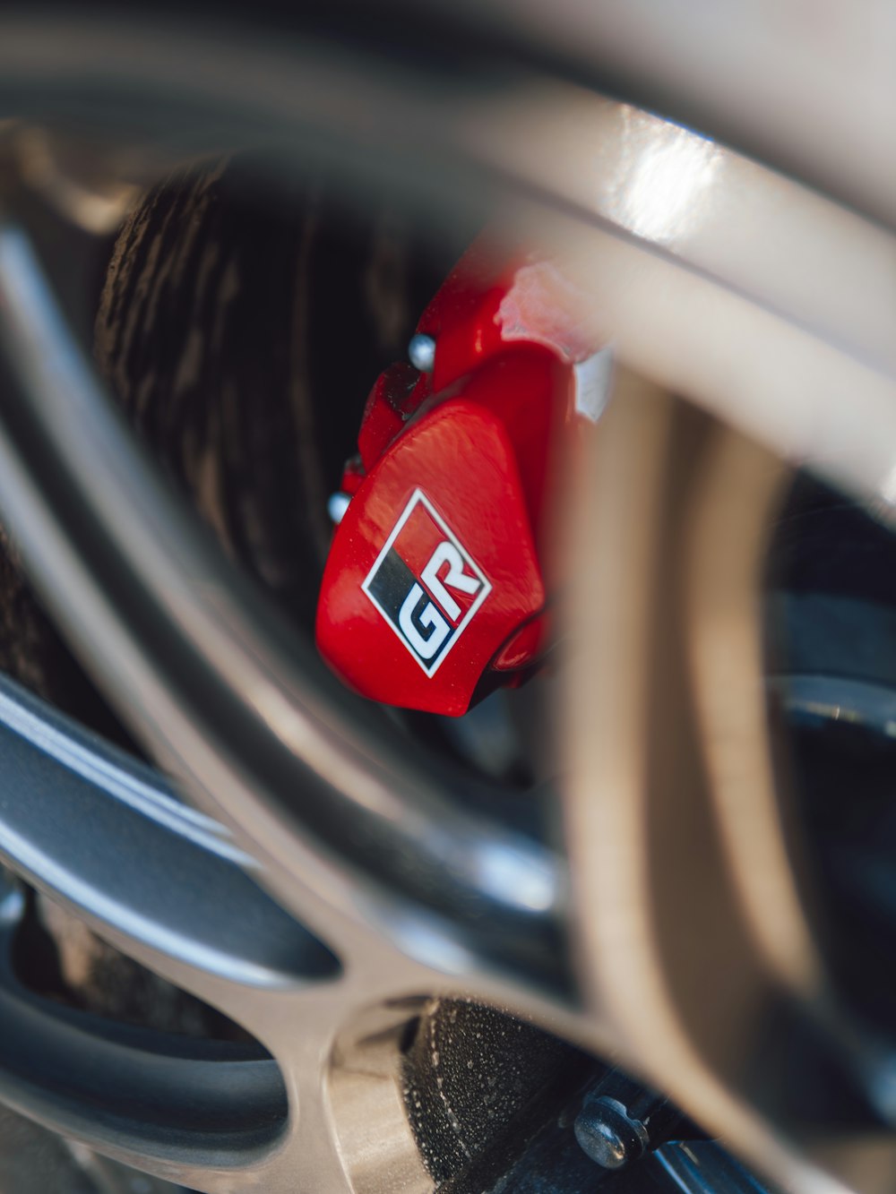 a close up of a red brake pad on a motorcycle