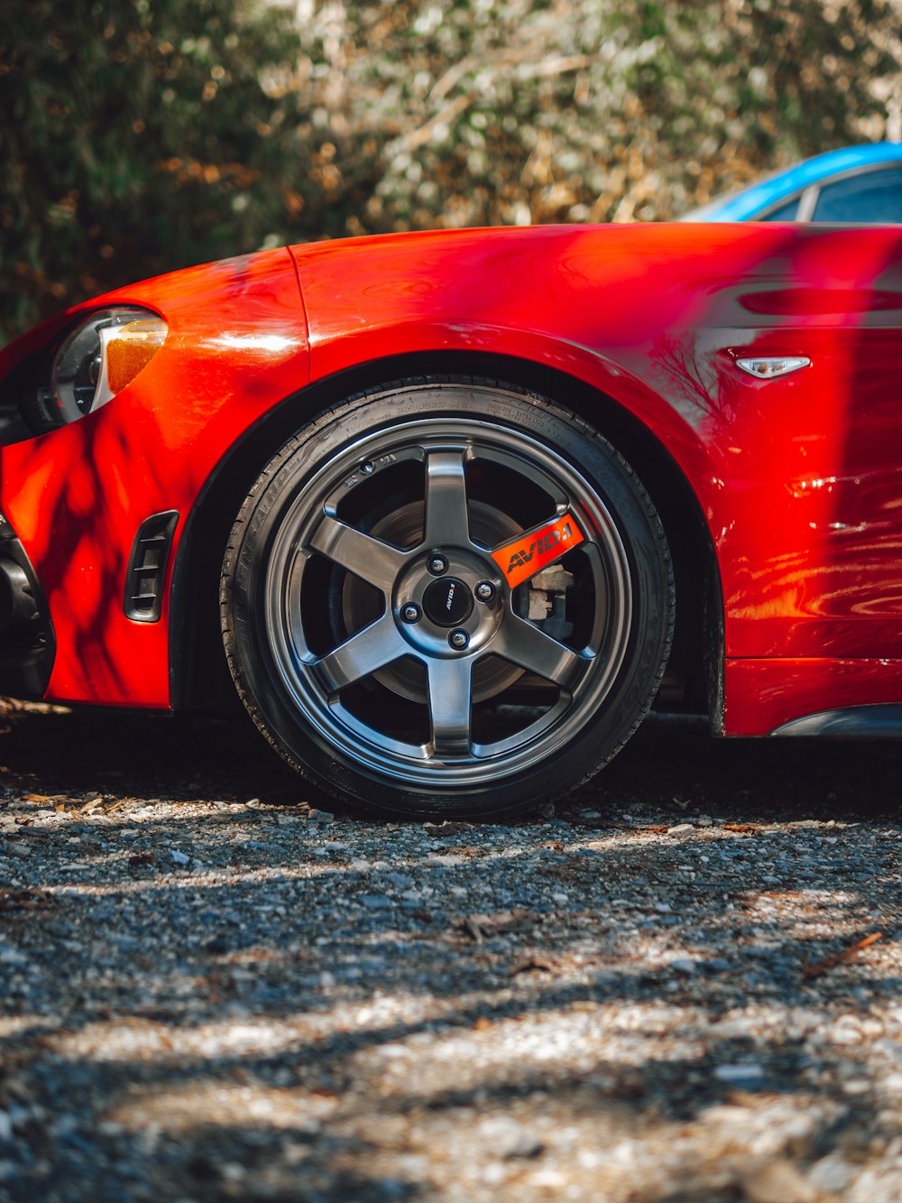 a red sports car parked on the side of the road