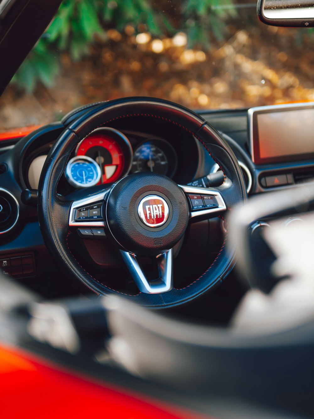 a close up of a steering wheel and dashboard of a car