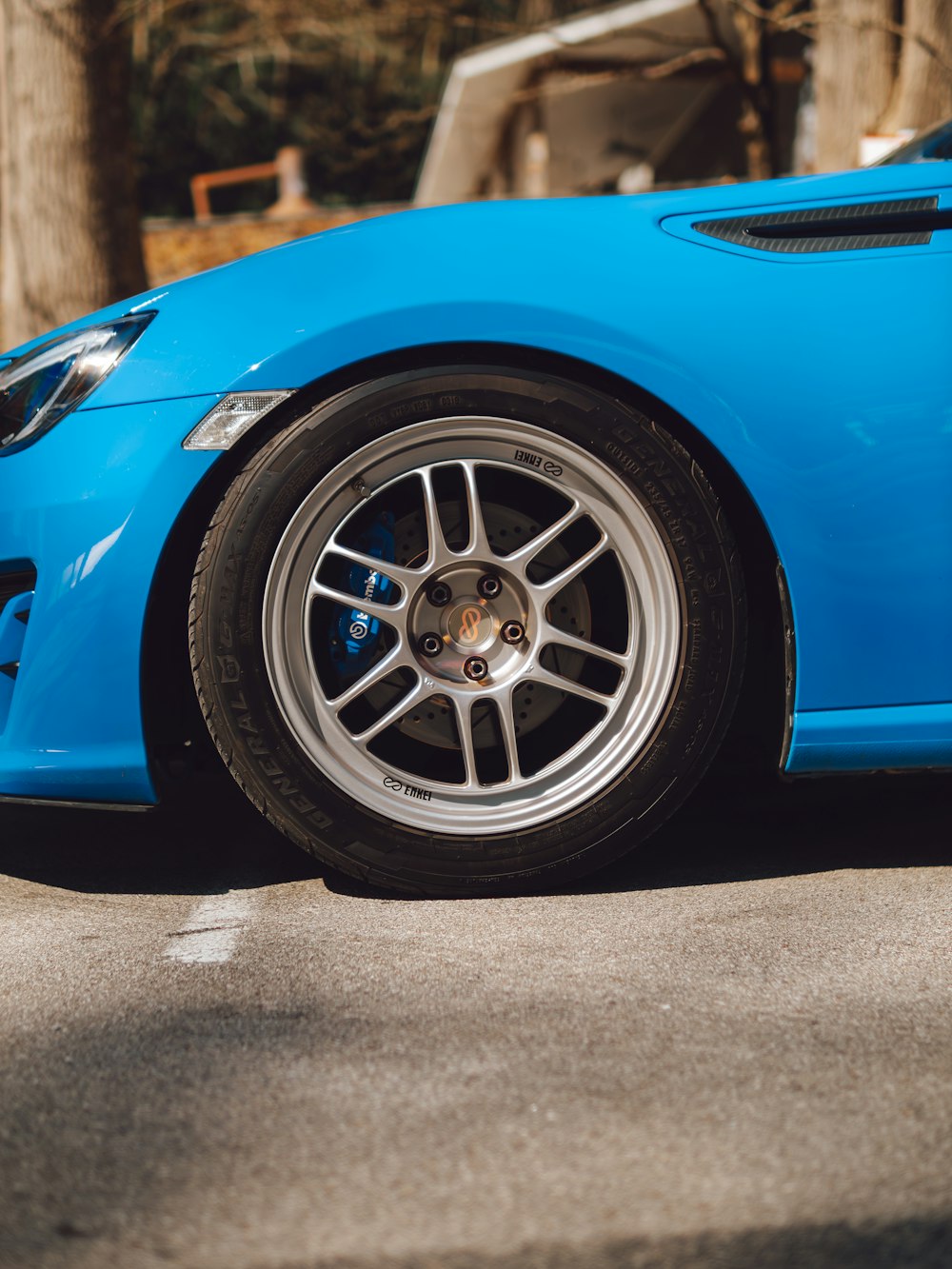 a blue sports car parked in a parking lot