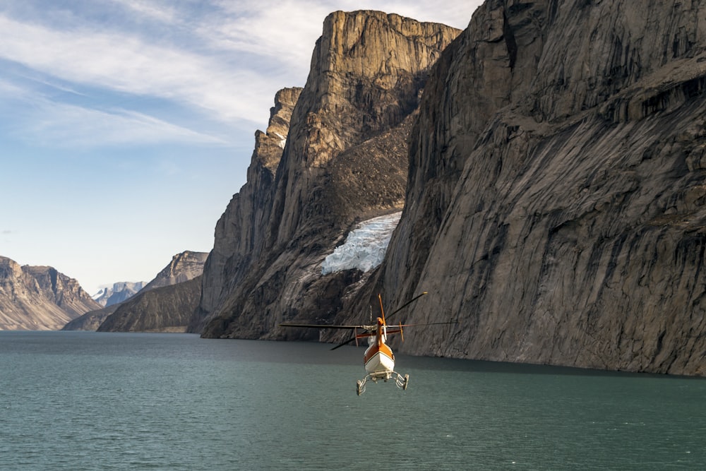 a helicopter that is flying over a body of water