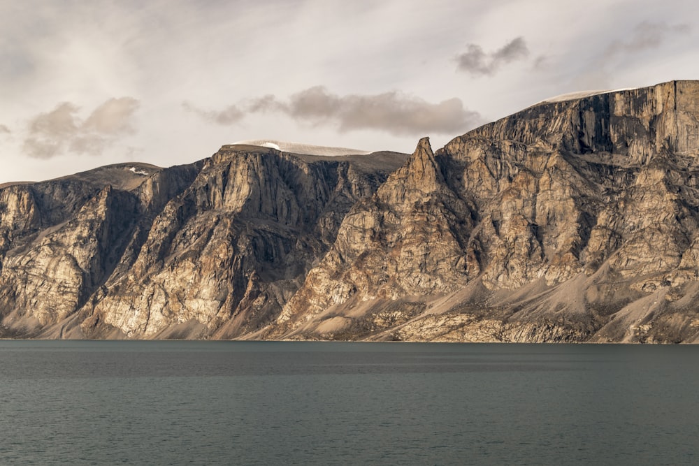 a large body of water with a mountain in the background