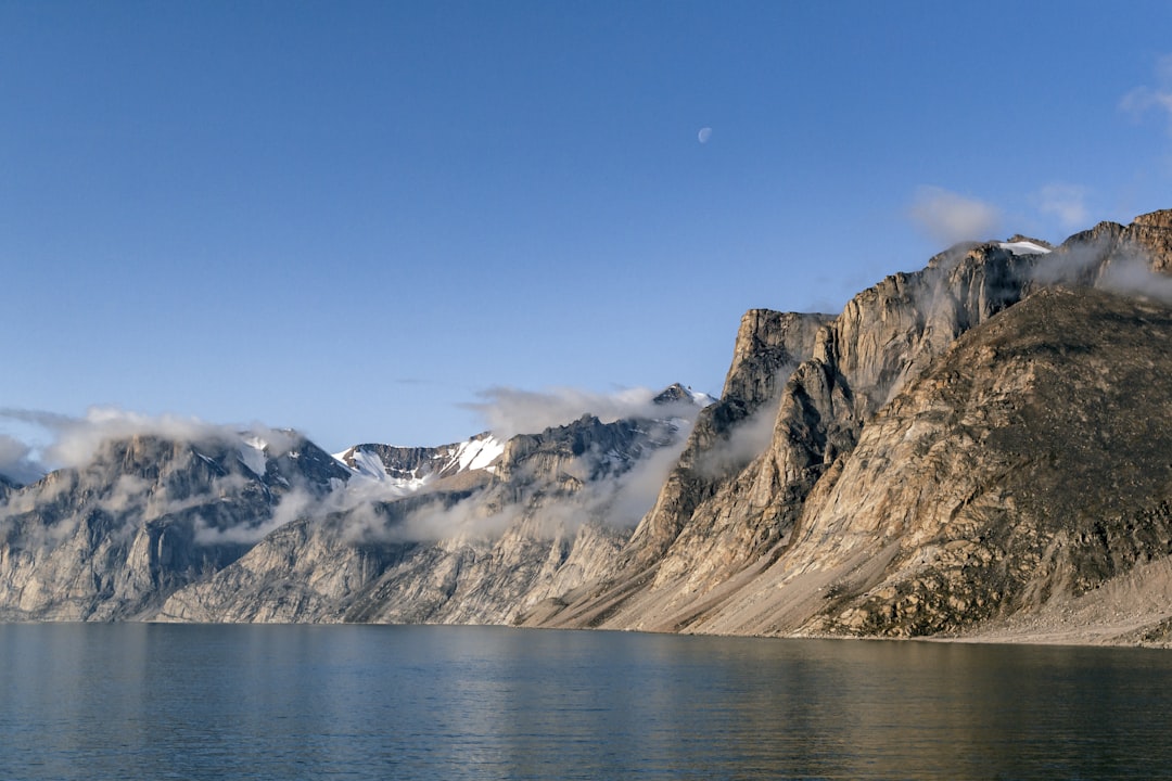 a mountain range with a body of water in front of it