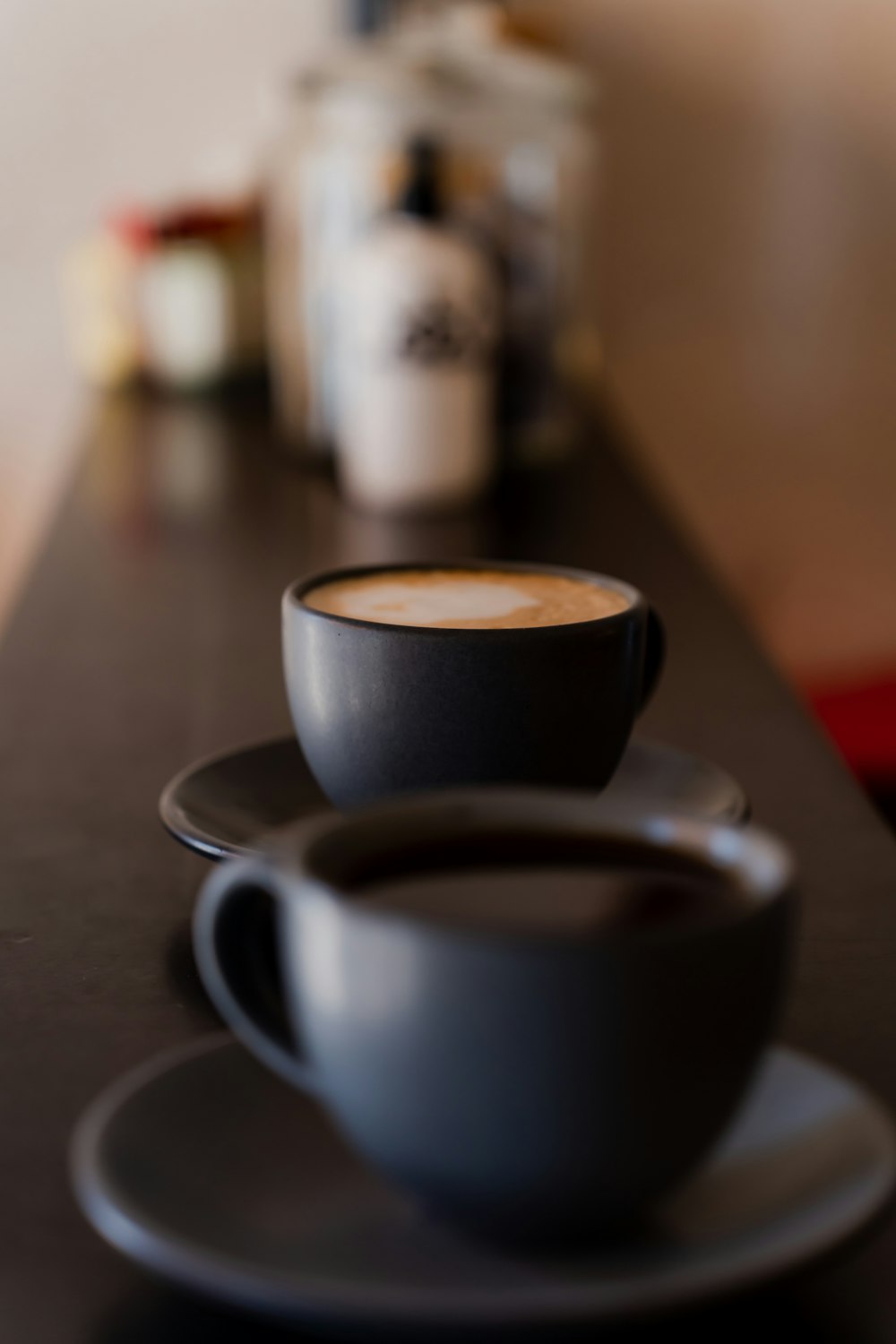 a couple of cups of coffee sitting on top of a table