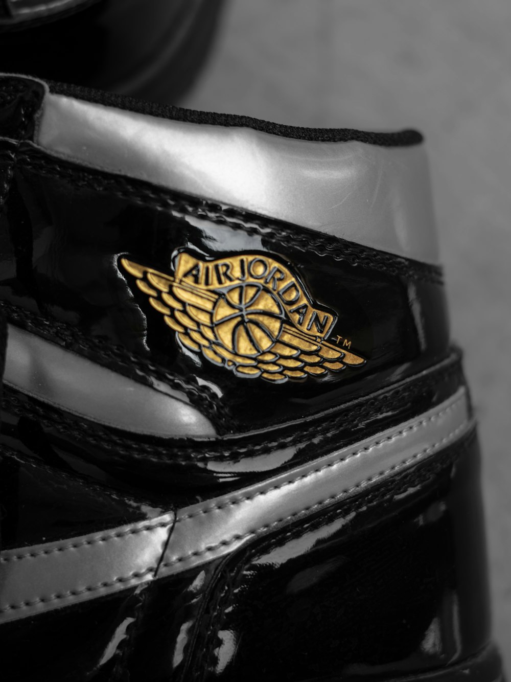 a close up of a pair of black and gold sneakers