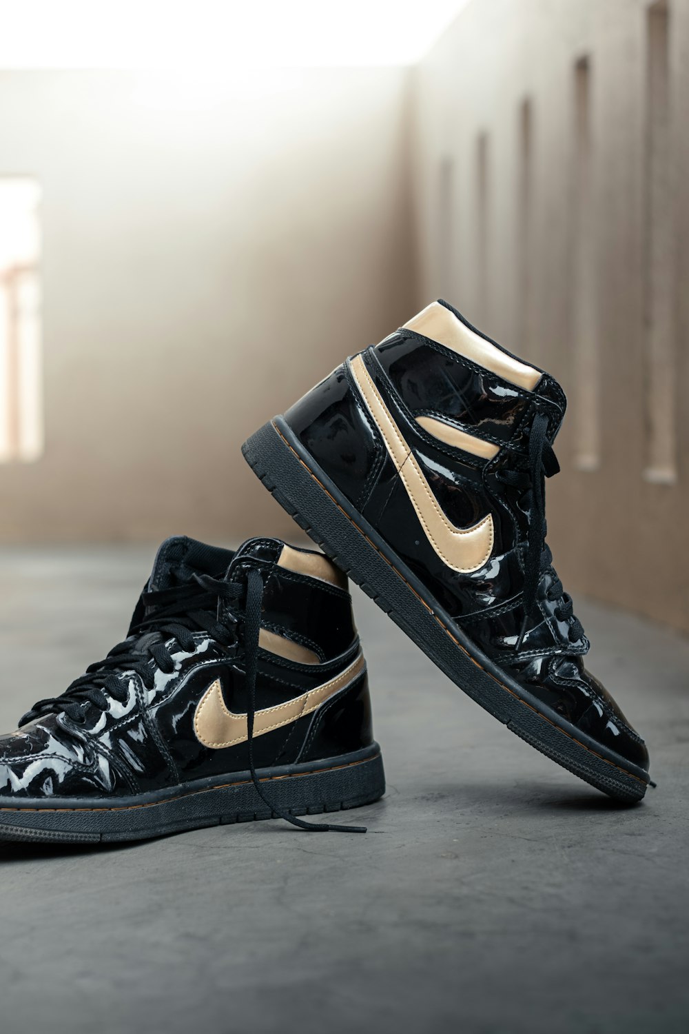 a pair of black and gold nike sneakers