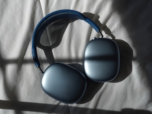 a pair of headphones sitting on top of a bed