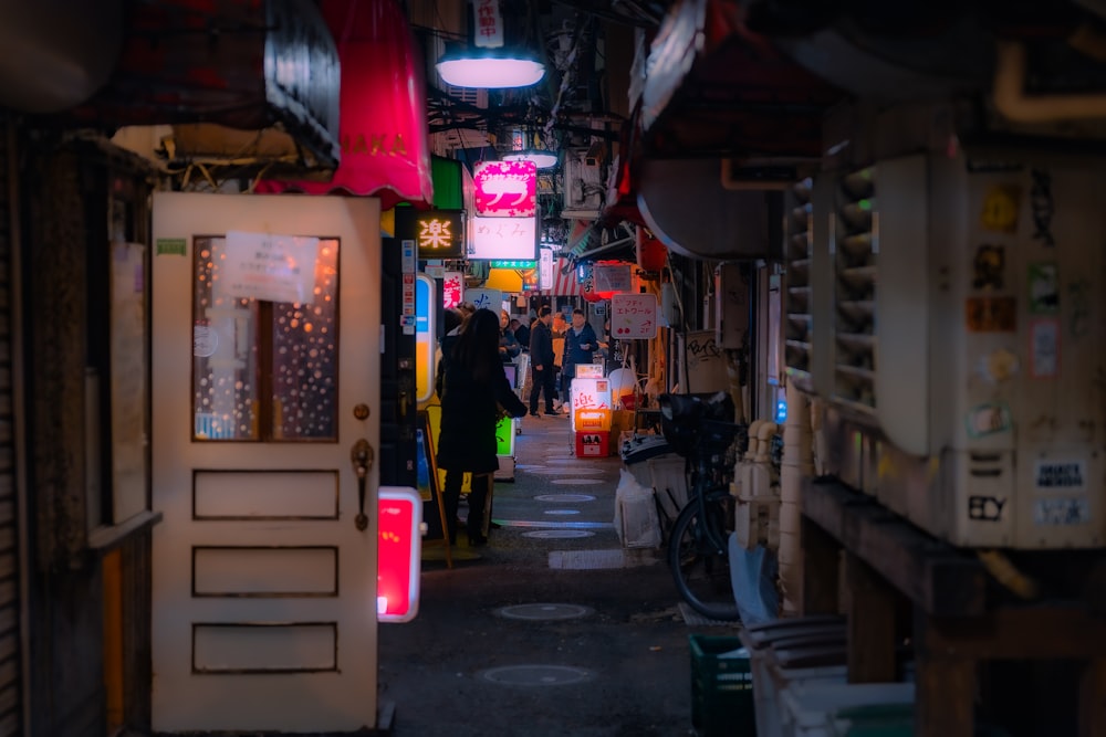 a narrow alley with a person walking through it