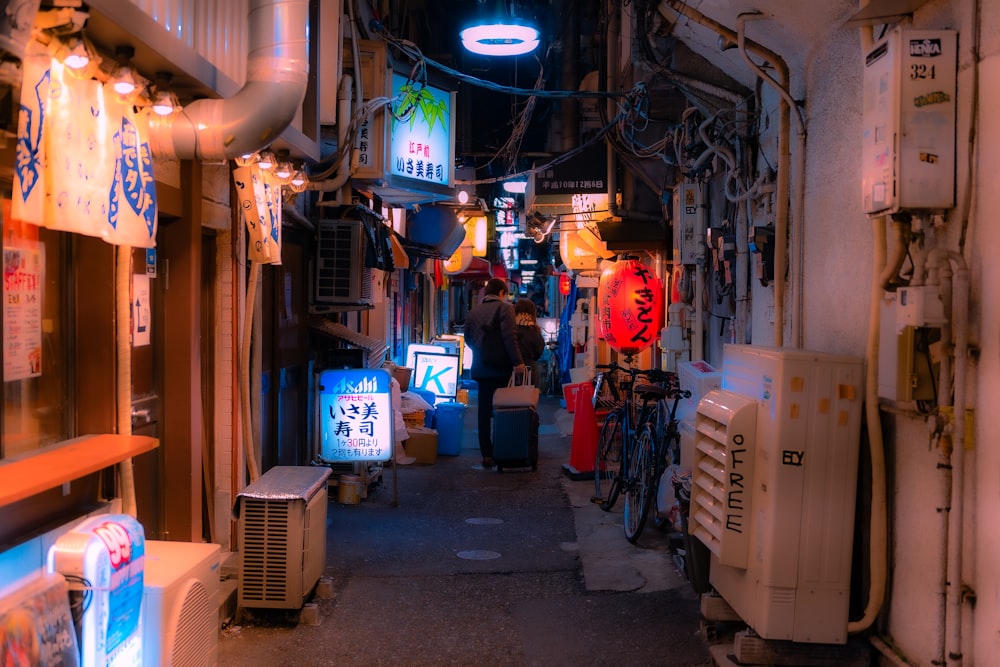 a narrow alley way with a television, refrigerator, and refrigerator freezer