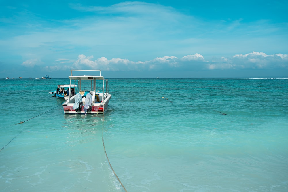 a couple of boats floating on top of a body of water