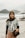 a woman standing on top of a sandy beach