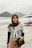 a woman standing on top of a sandy beach