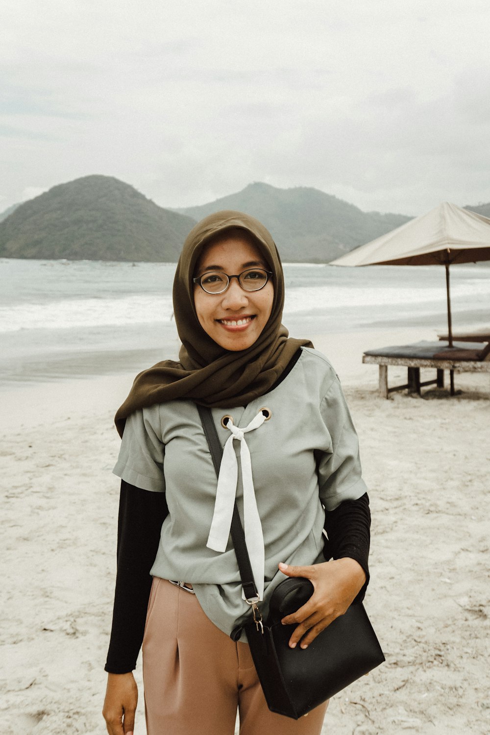 a woman standing on top of a sandy beach