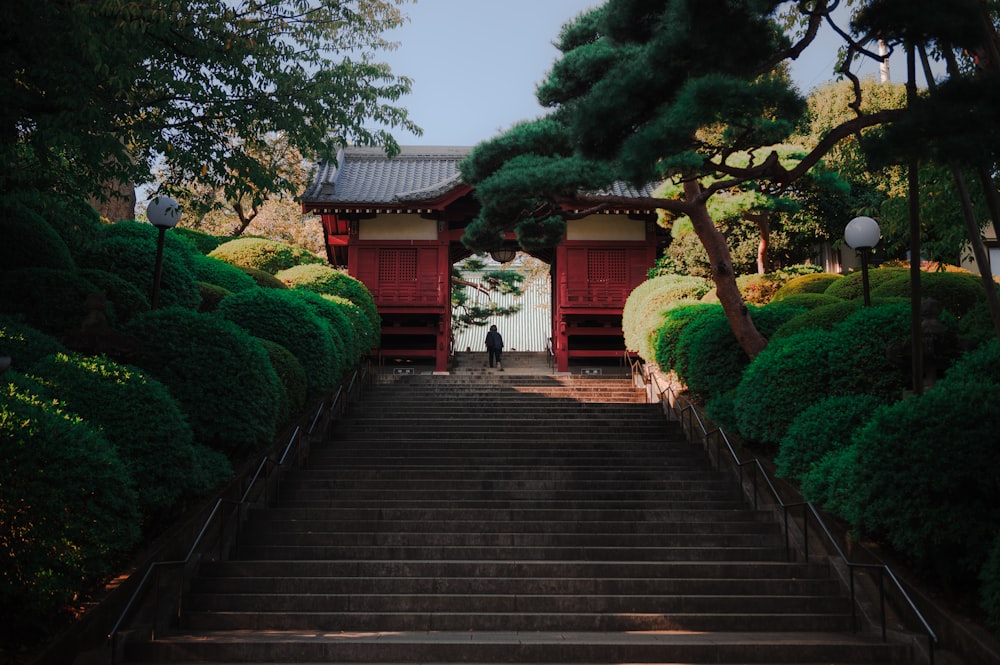 a set of stairs leading up to a red building